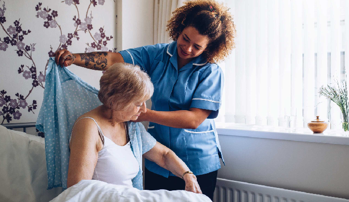 Nurse Is Assisting An Adult Woman In Her Daily Tasks