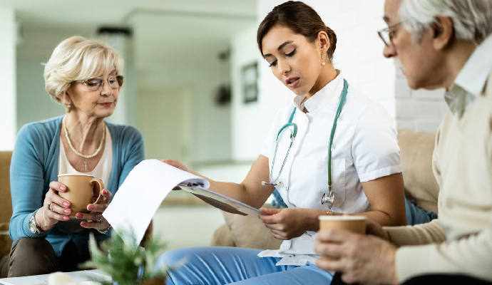 Young Healthcare Worker Senior Couple Analyzing Medical Test Results During Home Visit